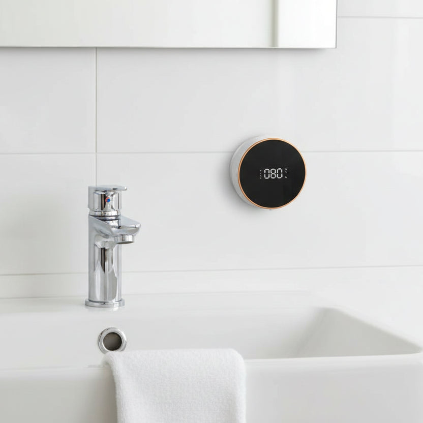 Wall-mounted automatic soap dispenser installed above sink, modern bathroom setup