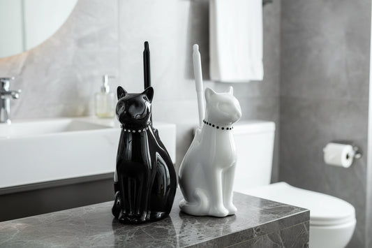 Black and white ceramic cat toilet brush holders displayed on bathroom countertop