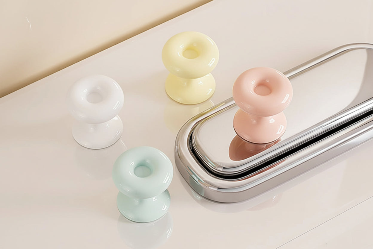 Decorative toilet flush button covers in pastel colours for modern bathroom design