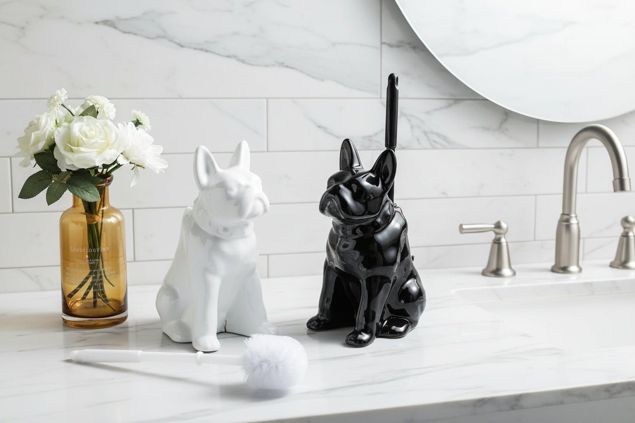 Black and white ceramic dog toilet brush holders displayed on a bathroom countertop next to sink and mirror