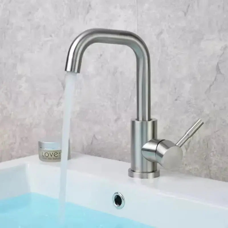 Stainless steel basin mixer tap installed on bathroom sink