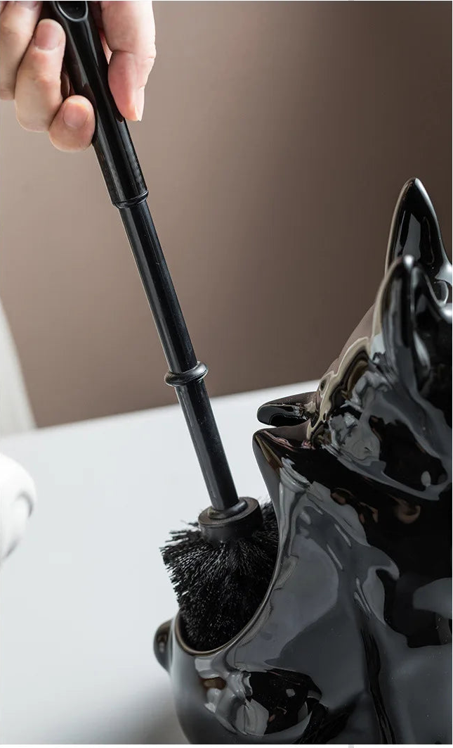 Black ceramic toilet brush holder with matching black toilet brush, close-up detail